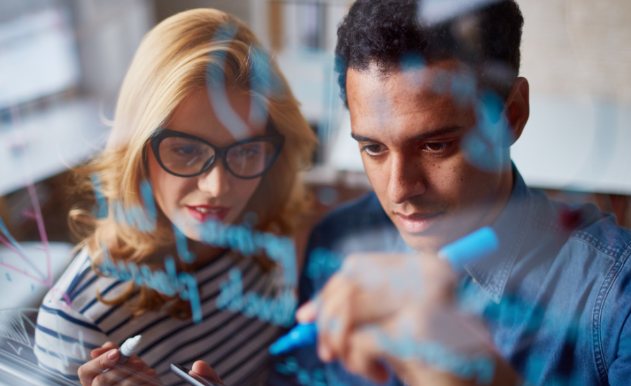 couple planning by writing on a transparent whiteboard